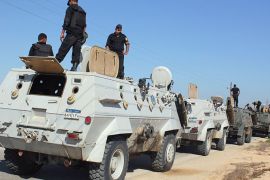 SINAI PENINSULA, -, EGYPT : Egyptian security forces stand by their Armoured Personell Carriers ahead of a military operation in the northern Sinai peninsula on August 08, 2012. Egypt, which launched air raids against Islamist militants in Sinai for the first time in decades, faces a tough enemy that has used the peninsula's rugged terrain to evade capture in the past. The military said it deployed Apache helicopter gunships in the strikes that killed 20 "terrorists" in the Sinai village of Tumah, in retaliation for a weekend ambush that cost the lives of 16 soldiers. AFP PHOTO/STRINGER