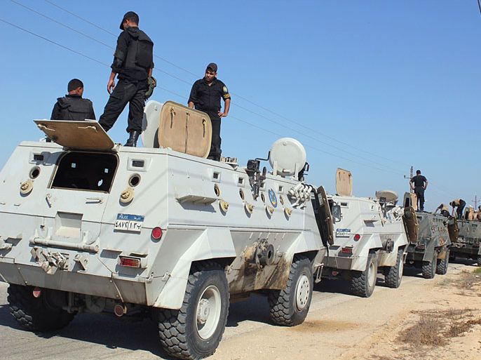 SINAI PENINSULA, -, EGYPT : Egyptian security forces stand by their Armoured Personell Carriers ahead of a military operation in the northern Sinai peninsula on August 08, 2012. Egypt, which launched air raids against Islamist militants in Sinai for the first time in decades, faces a tough enemy that has used the peninsula's rugged terrain to evade capture in the past. The military said it deployed Apache helicopter gunships in the strikes that killed 20 "terrorists" in the Sinai village of Tumah, in retaliation for a weekend ambush that cost the lives of 16 soldiers. AFP PHOTO/STRINGER