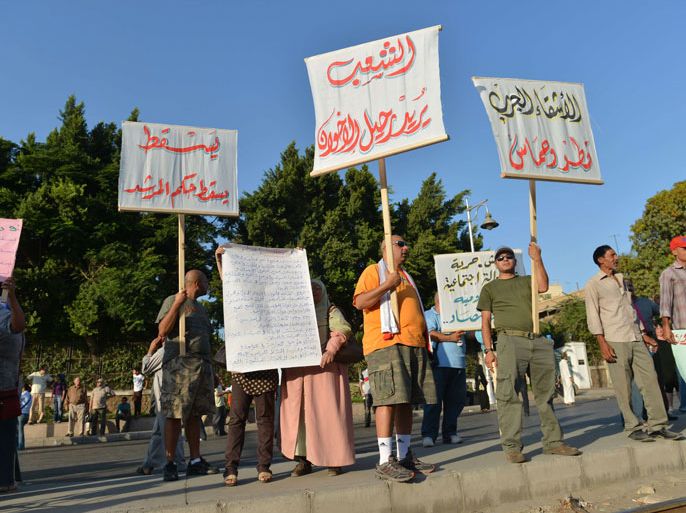 EGYPT : Several hundred Egyptian protesters demonstrate outside the presidential palace in northern Cairo against President Mohamed Morsi on August 24, 2012. The protests take place as Morsi, who assumed office amid a power struggle with the once-ruling military, consolidates his authority while two journalists critical of the president stand trial