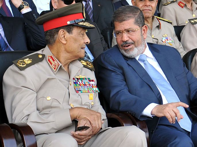 A file handout photograph dated 17 July 2012 and released by the Egyptian Presidency, shows Egyptian President Mohamed Morsi (R) speaking with Head of military council Field Marshal Mohammed Hussein Tantawi (L) during a graduation ceremony of military cadets at the Military Academy in Cairo, Egypt. According to media reports on 12 August 2012, Egyptian President Morsi ordered the powerful head of the army and defence minister, Field Marshal Tantawi and Chief of Staff Anan, into retirement and cancelled a constitution issued by the military restricting presidential powers. EPA/SHERIEF ABDUL MONAM/EGYPTIAN PRESIDENCY HANDOUT EDITORIAL USE ONLY/NO SALES