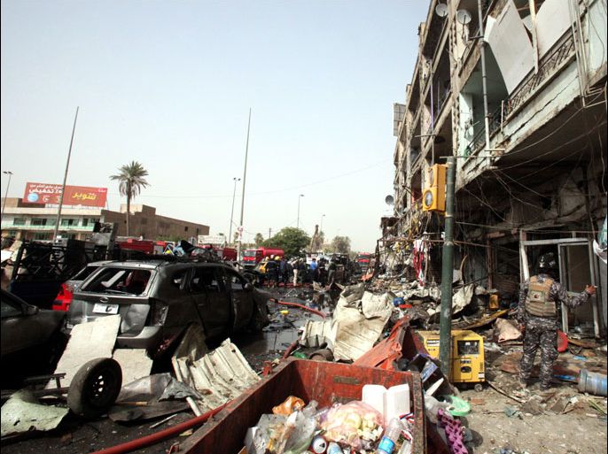 epa03329549 Iraqi security forces gather at the site of a car bomb attack in central Baghdad, Iraq, 31 July 2012. According to local reports, two successive car bombings at Andalus Square in central Baghdad left at least 13 people dead and 30 injured. EPA/AHMED JALIL