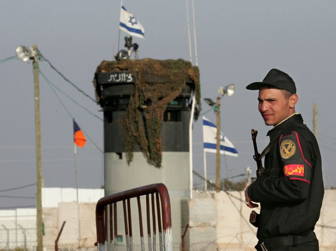 A picture taken on March 19, 2007 shows an Egyptian border policeman standing guard not far from an Israeli watch tower at the Karm Abu Salem border gate (Kerem Shalom in Hebrew) leading to the Philadelphi corridor, a buffer zone that separates Egypt from Israel and the Gaza Strip. Several Egyptian border guards were killed on August 5, 2012