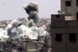 An image grab taken from a video uploaded on YouTube on August 11, 2012 allegedly shows smoke billowing from buildings in the al-Khalidiyah neighbourhood of the Syrian central city of Homs following shelling by forces loyal to President Bashar al-Assad