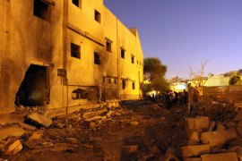 BENGHAZI, -, LIBYAN ARAB JAMAHIRIYA : People gather to inspect the damage to the Libyan Intelligence building following an explosion in downtown Benghazi on August 1 , 2012, causing no fatalities or injuries. AFP PHOTO/ABDULLAH DOMA