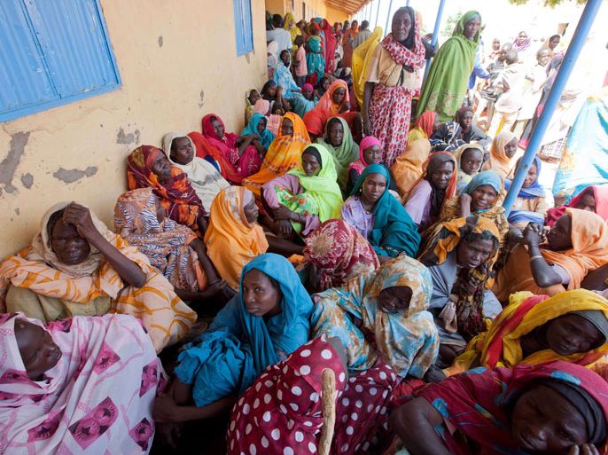 KUTUM, -, SUDAN : A handout picture released by the United Nations-African Union Mission in Darfur (UNAMID) shows Sudanese women waiting to be examined by doctors at a school used as a provisional medical centre near the Kassab camp, where more than 25, 000 Internally Displaced Persons (IDP) live, in the Norhtn Darfur town of Kutum on August 9, 2012. A new spurt of unrest in Darfur since last week saw security forces shoot dead eight protesters in the South Darfur city of Nyala, and troops deployed in the North Darfur town of Kutum where eight people died during looting and other violence. AFP PHOTO/UNAMID/ALBERT GONZALEZ FARRAN == RESTRICTED TO EDITORIAL USE - MANDATORY CREDIT "AFP PHOTO/UNAMID/ALBERT GONZALEZ FARRAN" - NO MARKETING NO ADVERTISING CAMPAIGNS - DISTRIBUTED AS A SERVICE TO CLIENTS