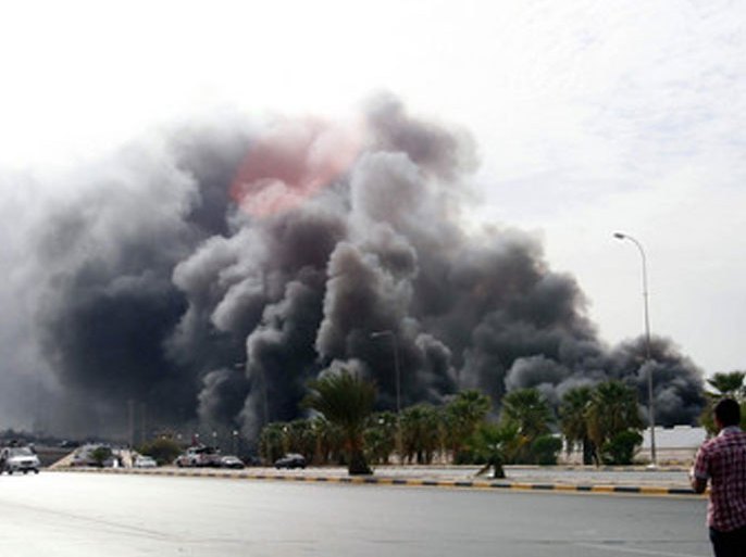 A genreal view shows, smoke rising from a warehouse, at naval base, in Tripoli, Libya, 24 September 2011. According to media sources, the warehouse for miilitary vehicle was set on fire by a series of explosions. The cause remains unknown. EPA/MOHAMED MESSARA