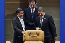 Egyptian President Mohamed Morsi (R) and his Iranian counterpart Mahmoud Ahmadinejad (L) arrive to attend the opening session of the Non-Aligned Movement summit in Tehran on August 30, 2012. Supreme leader Ayatollah Ali Khamenei opened the event with a speech blasting the United States as a hegemonic meddler and Israel as a regime of "Zionist wolves." AFP PHOTO/MEHR NEWS/MAJID ASGARIPOUR