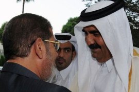 afp-A handout picture made available by the Egyptian presidency shows Egyptian President Mohamed Morsi (L) greeting the Emir of Qatar, Sheik Hamad bin Khalifa Al-Thani (R) at the Presidential Palace in Cairo on August 11, 2012