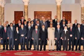 handout photograph released by the Egyptian Presidency shows Egyptian President Mohamed Morsi (C) posing for a photo with members of the new government following the swearing-in ceremony, in Cairo, Egypt, 02 August