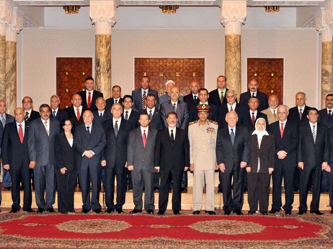 handout photograph released by the Egyptian Presidency shows Egyptian President Mohamed Morsi (C) posing for a photo with members of the new government following the swearing-in ceremony, in Cairo, Egypt, 02 August