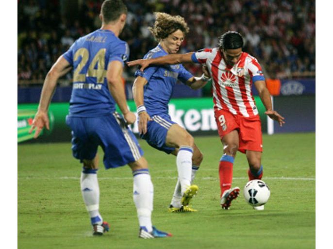 Chelsea's defenderS David Luiz (C) and Gary Cahill (L) fight for the ball with Atletico forward Falcao (R) during the UEFA Super Cup football match Chelsea FC versus Club Atletico Madrid, on August 31, 2012 at the Stade Louis II, in Monaco. Madrid won 4-1. AFP PHOTO / JEAN CHRISTOPHE MAGNENET