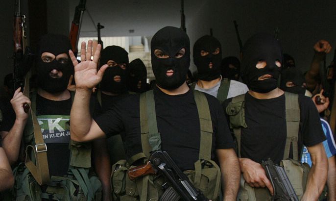 Lebanese masked gunmen from the al-Muqdad clan gather for a press conference in Beirut's southern suburbs on August 15, 2012. The Muqdads, a large Lebanese Shiite Muslim clan, said it has kidnapped at least 20 Syrians to try to secure the release of a family member abducted near Damascus this week