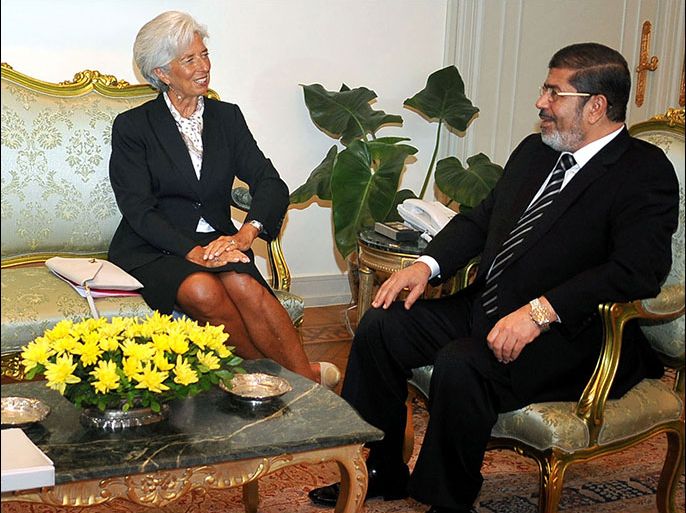 afp : A handout picture released by the Egyptian presidency shows Egyptian President Mohamed Morsi (R) meeting with International Monetary Fund (IMF) chief Christine Lagarde on August 22, 2012, upon her arrival in Cairo for talks on the Egyptian government's plans to reform and relaunch the national economy, as well as a "loan request of 4.8 billion US dollars (3.8 billion euros)," the official news agency said. AFP PHOTO/HO/EGYPTIAN PRESIDENCY