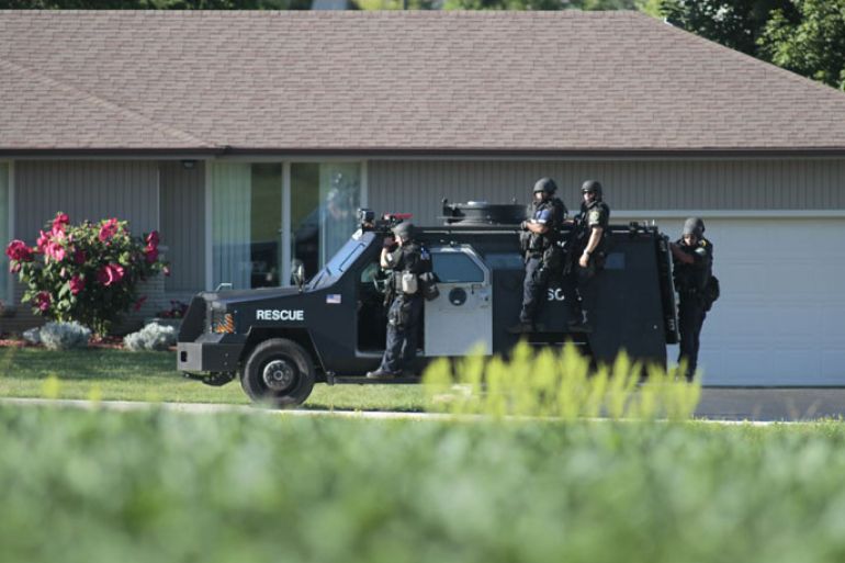 Oak Creek, Wisconsin, UNITED STATES : OAK CREEK - AUGUST 5: Various police personnel walk away from the site just outside of where swat teams had surrounded the Sikh Temple of Wisconsin where a gunman stormed the mass and opened fire August, 5, 2012 Oak Creek, Wisconsin. At least six people were killed when a shooter opened fire on congregants in the Milwaukee suburb. The shooter who was later shot dead by a police officer. Darren Hauck/Getty Images/AFP== FOR NEWSPAPERS, INTERNET, TELCOS &amp; TELEVISION USE ONLY ==