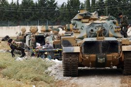 A Turkish military convoy stops for a moment while travelling to the border between Turkey and Syria, near the southeastern Turkish city of Kilis July 30, 2012. Turkey sent a convoy of about 20 vehicles carrying troops, missile batteries and armoured vehicles to the border with Syria on Monday