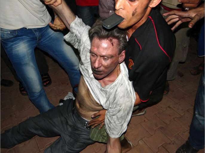 TOPSHOTS Libyan civilians help an unconscious man, identified by eyewitnesses as US ambassador to Libya Chris Stevens, at the US consulate compound in Benghazi in the early hours of September 12, 2012, following an overnight attack on the building. Stevens and three of his colleagues were killed in an attack on the US consulate in the eastern Libyan city by Islamists outraged over an amateur American-made Internet video mocking Islam, less than six months after being appointed to his post. AFP PHOTO/STR