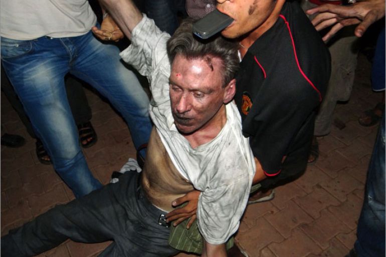 TOPSHOTS Libyan civilians help an unconscious man, identified by eyewitnesses as US ambassador to Libya Chris Stevens, at the US consulate compound in Benghazi in the early hours of September 12, 2012, following an overnight attack on the building. Stevens and three of his colleagues were killed in an attack on the US consulate in the eastern Libyan city by Islamists outraged over an amateur American-made Internet video mocking Islam, less than six months after being appointed to his post. AFP PHOTO/STR