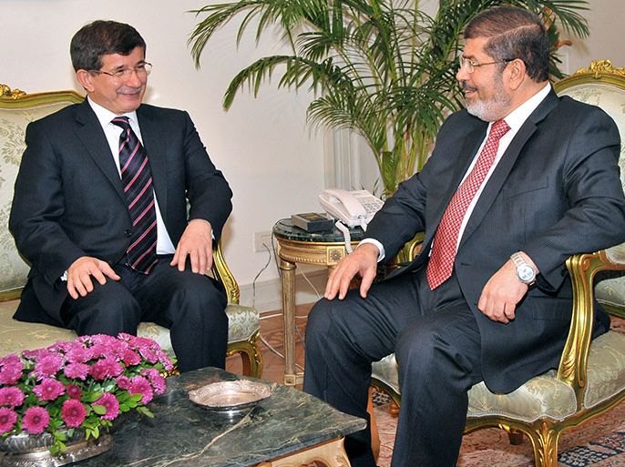 A handout picture from the Egyptian presidency shows Egyptian President Mohamed Morsi (R) meeting with Turkish Foreign Minister Ahmet Davutoglu in Cairo on September 17, 2012. Foreign ministers of the Syria "contact group" are expected to hold their first high-level meeting in Cairo to discuss developments in Syria on the political and humanitarian fronts. AFP PHOTO/HO/EGYPTIAN PRESIDENCY