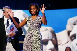 With an image of the Mount Rushmore National Memorial serving as a backdrop, U.S. first lady Michelle Obama tours the stage and podium a day before her speech to the Democratic National Convention in Charlotte, North Carolina, September 3, 2012.