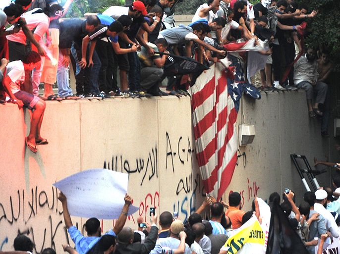 Egyptian protesters tear down the US flag at the US embassy in Cairo on September 11, 2012 during a demonstration against a film deemed offensive to Islam. Thousands of angry Egyptian demonstrators protested against the film made by an Israeli-American who describes Islam as a "cancer" as an armed mob attacked the US mission in Benghazi killing an official. AFP