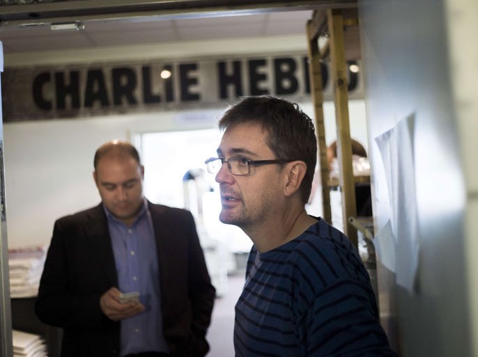 Paris, Paris, FRANCE : French satirical weekly Charlie Hebdo's publisher, known only as Charb, speaks to journalists, on September 19, 2012 in Paris, at the headquarters, after showing the last issue which features on the front cover a satirical drawing titled "Intouchables 2". Inside pages contain several cartoons caricaturing the Prophet Mohammed. The magazine's decision to publish the cartoons came against a background of unrest across the Islamic world over a crude US-made film that mocks Mohammed and portrays Muslims as gratuitously violent. The title refers to "Intouchables", a 2012 French movie, the most seen French movie abroad, which is selected to represent France for the Oscars nominees, according to one of his directors, Eric Toledano. AFP PHOTO FRED DUFOUR