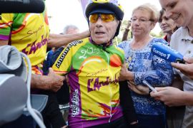 Robert Marchand, 100 years old, answers journalists' questions after beating the 100 km record by a centenarian, on September 28, 2012 at the Lyon's velodrome, central France. AFP PHOTO PHILIPPE DESMAZES