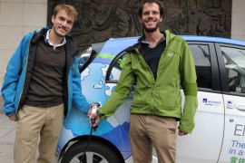 French engineers Antony Guy (L) and Xavier Degon pose at the Economy Ministry in Paris on September 25, 2012, while holding a plug into their Citroen C-Zero electric car in which they achieved a 200-day "electric odyssey" trip over the world. The two young engineers started in February 2012, driving more than 25.000 km through 17 countries including Russia, China