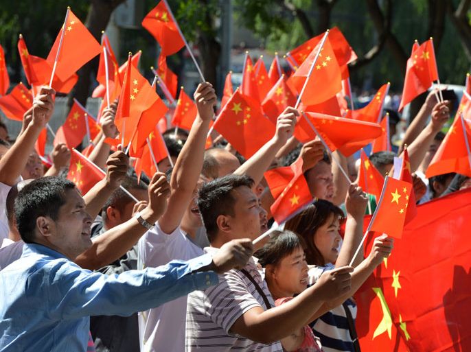 Beijing, -, CHINA : TOPSHOTS Anti-Japanese demonstrators wave the Chinese flag as protests continue outside the Beijing Japanese Embassy over the Diaoyu Islands issue, known as the Senkaku Islands in Japanese, on September 14, 2012. Six Chinese ships sailed into waters around a disputed archipelago, with Beijing saying they were there for "law enforcement" around islands Japan nationalised earlier this week. AFP PHOTO/Mark RALSTON