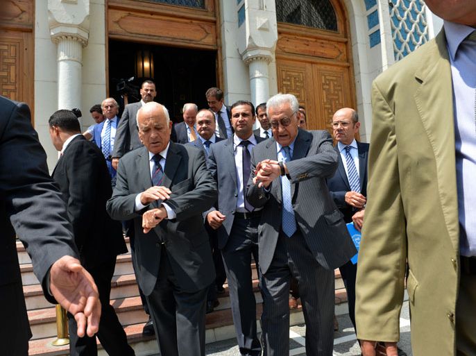 Cairo, -, EGYPT : UN and Arab League envoy for Syria Lakhdar Brahimi (2nd R) and Arab League General Secretary Nabil al-Arabi (3 rd L) look at their watches as they leave the Arab League's headquarters in Cairo following a press conference on September 10, 2012. Brahimi said that he faces a "very difficult mission" in conflict-stricken Syria, as he prepared to visit Damascus. AFP PHOTO / KHALED DESOUKI
