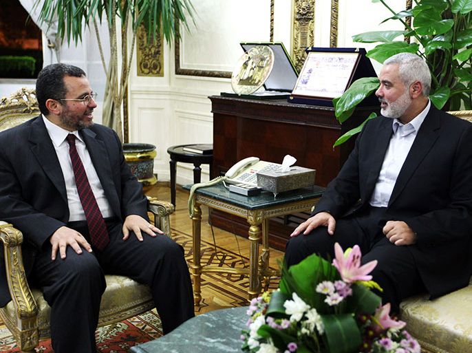 afp : A handout picture released by the office of Ismail Haniya shows the latter, head of the Hamas government in the Gaza Strip, meeting with Egyptian Premier Hisham Qandil (L) in Cairo on September 17, 2012. AFP PHOTO/HO/ISMAIL HANIYA'S OFFICE == RESTRICTED TO EDITORIAL USE - MANDATORY CREDIT "AFP PHOTO/HO/ISMAIL HANIYA'S OFFICE" - NO MARKETING NO ADVERTISING CAMPAIGNS - DISTRIBUTED AS A SERVICE TO CLIENTS ==