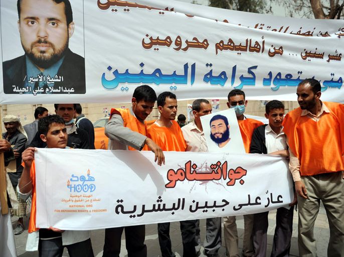 epa03152435 Yemenis hold banners with the portrait of a Yemeni detainee in the US-run Guantanamo military base, during a rally asking for the release of Yemeni detainees, in Sana'a, Yemen, 20 March 2012. According to media reports, approximately 90 Yemeni nationals are currently held in Guantanamo Bay. They make up the largest contingent of the remaining detainees at the offshore US facility. EPA/YAHYA ARHAB