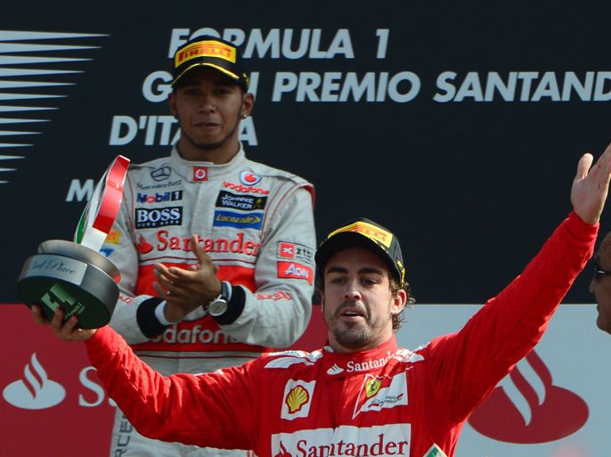 (L to R) McLaren Mercedes' British driver Lewis Hamilton and Ferrari's Spanish driver Fernando Alonso celebrate on the podium at the Autodromo Nazionale circuit on September 9, 2012 in Monza after the Italian Formula One Grand Prix