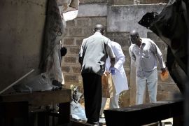 Investigators inspect the site where a blast ripped through a church in Nairobi on September 30, 2012. A suspected grenade attack killed one child and wounded nine others in a Nairobi church today, a day after Islamist fighters