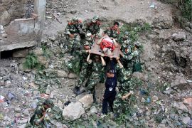 Soldiers carry an injured person with a stretcher towards safer area after two earthquakes hit Zhaotong, Yunnan province, September 7, 2012. Two shallow 5.6 magnitude earthquakes hit mountainous southwestern China on Friday, killing at least 64 people and forcing tens of thousands of people from damaged buildings, state media said. REUTERS/Stringer (CHINA - Tags: DISASTER ENVIRONMENT) CHINA OUT. NO COMMERCIAL OR EDITORIAL SALES IN CHINA