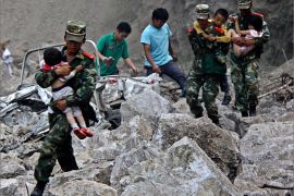 Soldiers carry children as locals follow them towards safer area after two earthquakes hit Zhaotong, Yunnan province, September 7, 2012. Two shallow 5.6 magnitude earthquakes hit mountainous southwestern China on Friday, killing at least 64 people and forcing tens of thousands of people from damaged buildings, state media said. REUTERS/Stringer (CHINA - Tags: DISASTER ENVIRONMENT) CHINA OUT. NO COMMERCIAL OR EDITORIAL SALES IN CHINA