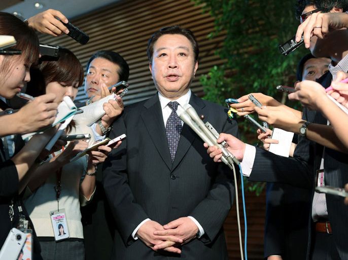 Tokyo, Tokyo, JAPAN : Japanese Prime Minister Yoshihiko Noda is surrounded by reporters before leaving to New York to attend the United Nations General Assembly, at his official residence in Tokyo on September 24, 2012. Noda warned China, in an interview published on September 23, that its tough and uncompromising stance taken in a territorial dispute with Japan could weaken the Chinese economy. AFP PHOTO / JIJI PRESS JAPAN OUT