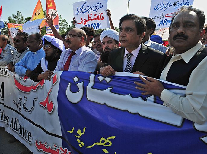 Pakistani Minister for Interfaith Harmony Paul Bhatti (2R) marches during a protest rally against the anti-Islam film called by the All Parties Minorities Alliance (APMA) in Islamabad on September 23, 2012. The Pakistan government distanced itself Sunday from a 100,000 dollar bounty offered by a cabinet minister for the death of the maker of an anti-Islam film that has sparked protests across the Muslim world. AFP