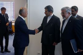 Iran's envoy to the International Atomic Energy Agency (IAEA) Ali Asghar Soltanieh (2R), smiles as Iran's head of Atomic Energy Organisation Fereydoon Abbasi Davani (C), and International Atomic Energy Agency (IAEA) General-Director Yukiya Amano (2L) shake hands before a meeting as part of the 56th IAEA General Conference at the IAEA headquarters in Vienna on September 17, 2012. AFP PHOTO / ALEXANDER KLEIN
