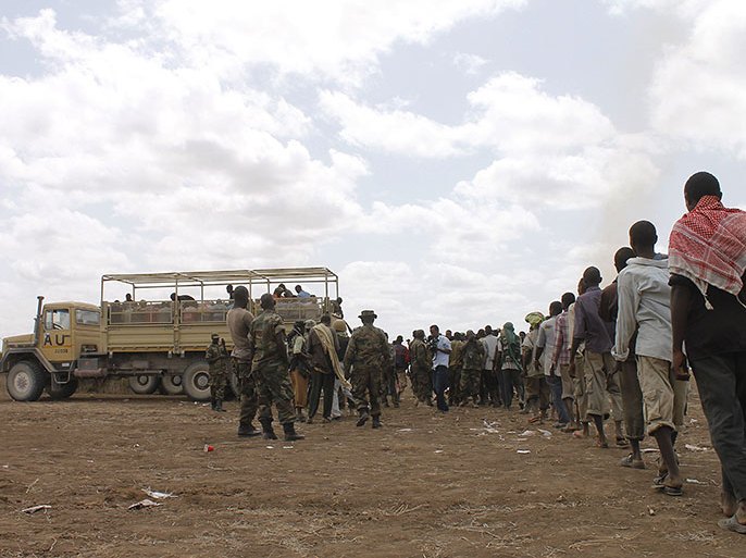 Photo taken September 22, 2012 shows members of the Al-Qaeda linked Shebab standing in line to get into AU trucks after giving themselves up to forces of the African Union Mission in Somalia (AMISOM) in Garsale, some 10km from the town of Jowhar, 80km north of the capital Mogadishu. Over 200 militants disengaged following in-fighting between militants in the region in which eight supporters of Shabaab were killed, including two senior commanders. The former fighters were peacefully taken into AMISOM's protection handing in over 80 weapons in the process, in a further indication that the once-feared militant group is now divided and being defeated across Somalia. Deputy Force Commander of AMISOM Operations, Brigadier Michael Ondoga said a number of militants have contacted the AU force indicating their wish to cease fighting and that they their safety is assured if they give themselves up peacefully to AMISOM forces. AFP
