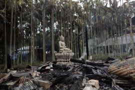 Ramu, -, BANGLADESH : A statue of Lord Buddha is left standing amidst the torched ruins of the Lal Ching Buddhist temple at Ramu, some 350 kilometres (216 miles) from the capital Dhaka on September 30, 2012. Thousands of rioters torched Buddhist temples and homes in southeastern Bangladesh Sunday over a photo posted on Facebook deemed offensive to Islam, in a rare attack against the community. AFP