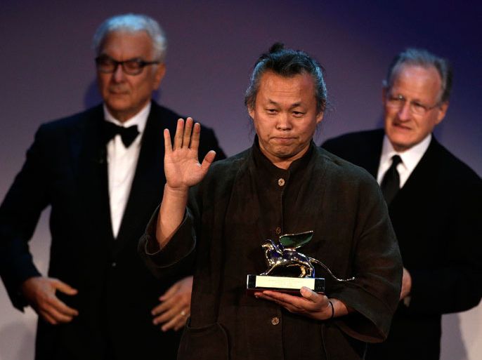 South Korean director Kim Ki-duk celebrates after receiving the Golden Lion prize for best movie "Pieta" at the 69th Venice Film Festival in Venice September 8, 2012. REUTERS/Tony Gentile (ITALY - Tags: ENTERTAINMENT)