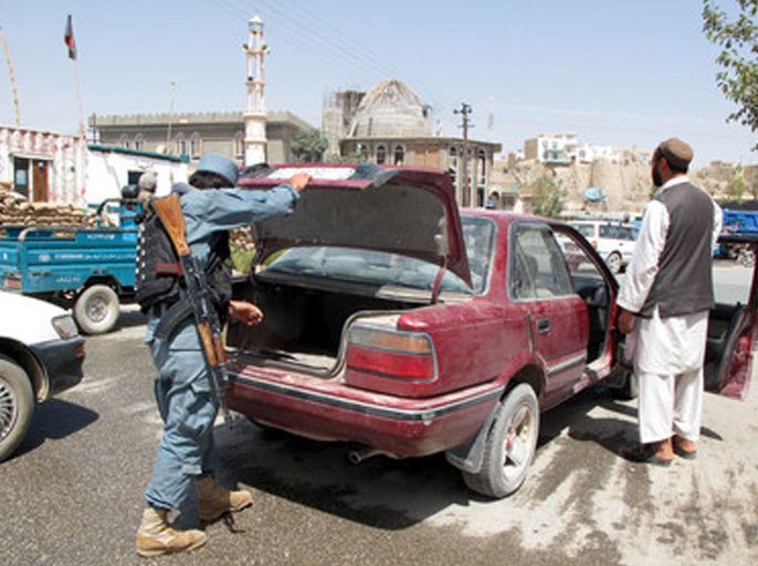 Afghan police officials control a vehicle at a checkpost after twin suicide bomb attack in neighboring Wardak province outside the NATO base, in Ghazni, Afghanistan, 01 September 2012. At least 12 people were killed and 59 others injured on 01 September in two suicide attacks in central Afghanistan, officials said. “A suicide attacker blew his explosive vest at the gate of Sayedabad district building in Wardak province and subsequently his colleague detonated his explosive-filled truck,” the provincial office said. “Eight civilians including a woman with four police officers were killed in the incidents, while 47 civilians, seven police and three intelligence officers were injured,” it, adding that two soldiers with the NATO-led military coalition were also wounded. The attack occurred near a military base. EPA/NAWEED HAQJOO