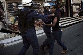 A Bahraini Shiite protester is detained by riot police during an anti-government demonstration in the centre of the capital Manama on September 21, 2012. AFP PHOTO/MOHAMMED AL-SHAIKH
