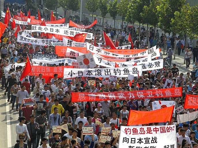 epa03398333 People march in a anti-Japan protest in Zhengzhou in central China's Henan province 15 September 2012. Reports state that major Chinese cities are expected to witness massive anti-Janpan protests this weekend, sparkled by the Japan's nationalization of disputed Senkaku Islands, which are called Diaoyu Islands in China. EPA