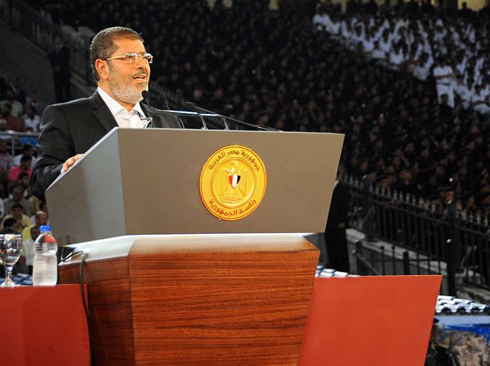 This handout picture taken and released by the Egyptian President's office on early October 7, 2012, shows President Mohamed Morsi delivering his speech to the nation in Cairo Stadium, in Cairo, to mark the 39th anniversary of the Yom Kippur war against Israel. AFP PHOTO / HO / EGYPTIAN PRESIDENCY == RESTRICTED TO EDITORIAL USE - MANDATORY CREDIT "AFP PHOTO/HO/EGYPTIAN PRESIDENCY" - NO MARKETING NO ADVERTISING CAMPAIGNS - DISTRIBUTED AS A SERVICE TO CLIENTS ==