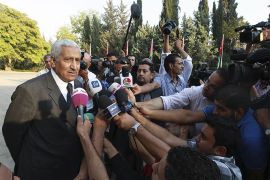 Jordan's new Prime Minister Abdullah Ensour (L) speaks to the media after the swearing-in ceremony for the new cabinet at the Royal Palace in Amman October 11, 2012. King Abdullah swore in a new government on Thursday led by reformist politician Ensour and charged with preparing for Jordan's first post-Arab Spring parliamentary elections.