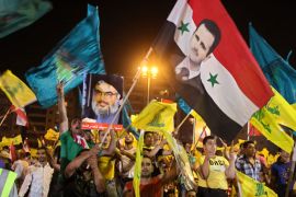 Hezbollah supporters wave Hezbollah and Syrian flags with a picture of Syrian President Bashar Assad, right, and Hezbollah leader Sheik Hassan Nasrallah, left, during a rally marking the sixth anniversary of the 2006 Israel-Hezbollah war, in Beirut's southern suburb, Lebanon, Wednesday, July 18, 2012. Nasrallah condemned an attack that killed three regime leaders in Damascus Wednesday, calling them "comrades" in the struggle against Israel. He said "the most important rockets" that Hezbollah fired on Israel in the 2006 war came from Syria.