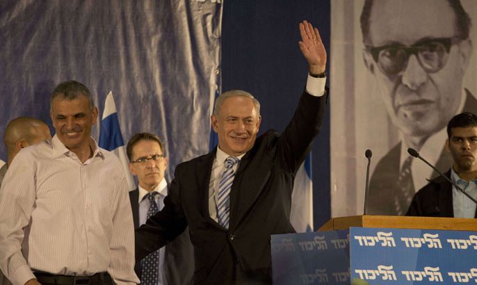 MK497 - Tel Aviv, -, ISRAEL : Israeli Prime Minister and Chairman of the Likud party Benjamin Netanyahu (C) waves to the crowd on stage next to the Minister of Welfare and Social Services Moshe Kahlon (L) during the Likud party’s central convention on October 29, 2012 in the Mediterranean coastal city of Tel Aviv. The convention approved Netanyahu’s proposal to merge the Likud party with Foreign Minister Avigdor Lieberman’s ultra-nationalist Yisrael Beitenu party in the upcoming January 22 national elections. AFP PHOTO/MENAHEM KAHANA