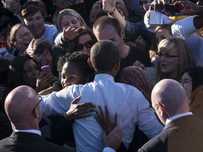 US President Barack Obama greets supporters after speaking during a campaign event at the Oval at Ohio State University October 9, 2012 in Columbus, Ohio. Obama is on the final day of a three day trip to California and Ohio for campaigning and speaking at the Cesar Chavez memorial. AFP PHOTO/Brendan SMIALOWSKI