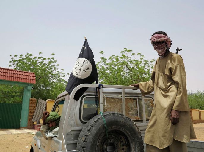 Fighters from the Islamic militant group the Movement for Unity and Jihad in West Africa (MUJWA) ride on a truck in the northeastern Malian city of Gao September 7, 2012. The group said on Sunday the killing of 16 Muslim preachers including eight Mauritanians and eight Malians by an army patrol in Mali was a declaration of war